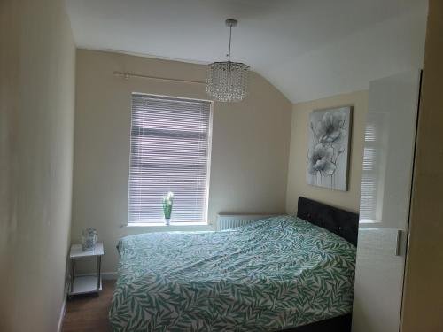 a bedroom with a bed in front of a window at Comfy one bedroom flat in Tilehurst