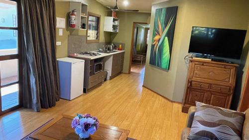an open living room with a kitchen and a living room at Luxury in Wailoaloa in Nadi