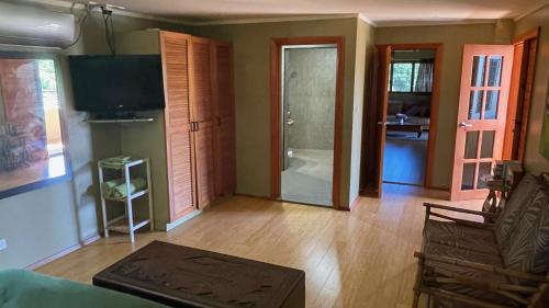 a living room with a couch and a television at Luxury in Wailoaloa in Nadi