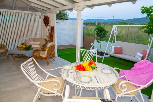 a table with a bowl of fruit on a patio at Island house in Psakoudia