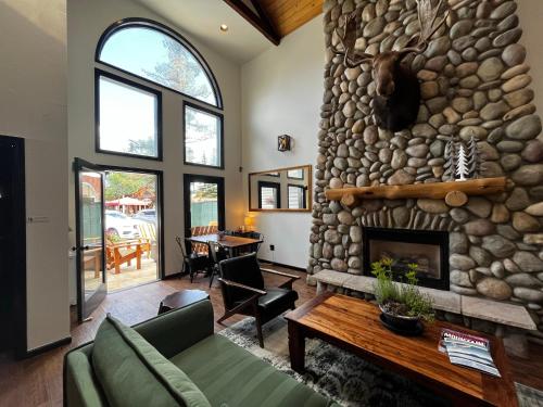 a living room with a large stone fireplace at Hotel Frisco in Frisco