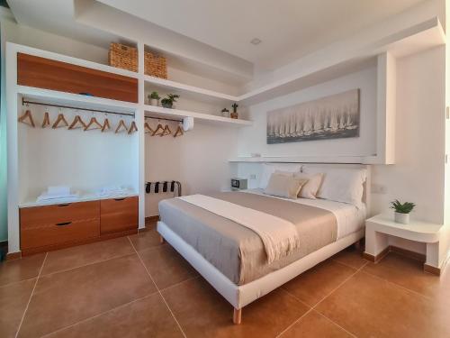 a bedroom with a large bed and a window at Don Antonio Rooms in Agropoli