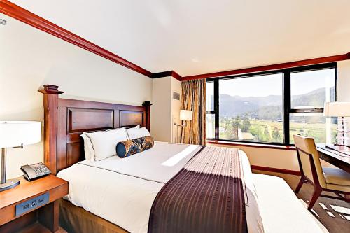 a bedroom with a bed and a desk and a window at Resort at Everline Resort & Spa #558 in Olympic Valley