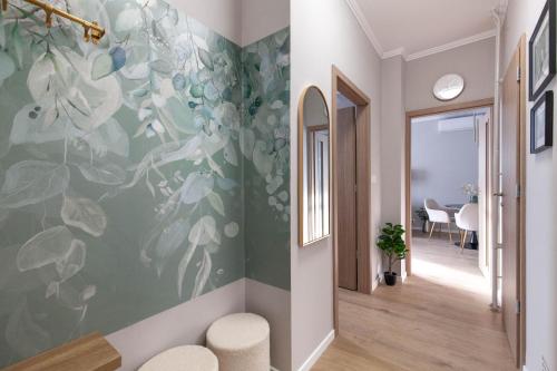 a hallway with a wall mural of flowers at SMARAGD-Emerald in Veszprém