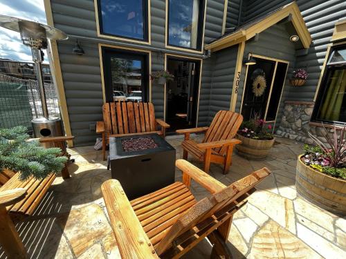 a patio with two wooden chairs and a grill at Hotel Frisco in Frisco