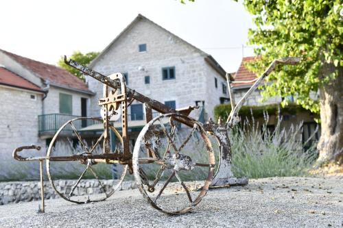 a rusty bike sitting on the side of a street at Great place for relaxation in Gornji Proložac
