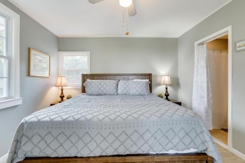 a bedroom with a large bed and two lamps at Swimmin' Hole in Bonneau