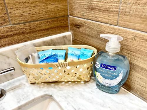 a basket of toothpaste and a bottle of detergent on a sink at 408 Modern styles apartment in center city of Philly in Philadelphia