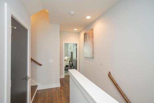 a hallway of a home with white walls at Luxury Townhome Skyline Views Mins To DT in Nashville
