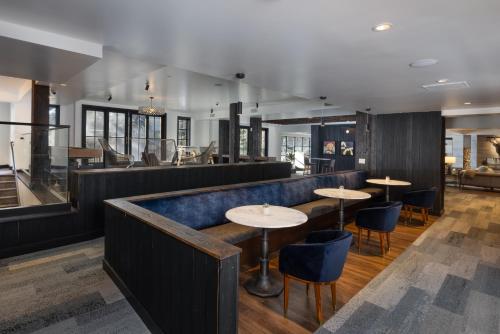 a bar with tables and chairs in a restaurant at Gravity Haus Vail in Vail