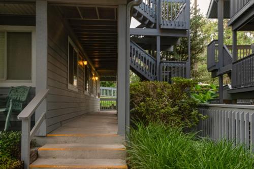 a walkway leading to a house with blue stairs at River Song in Dunnellon