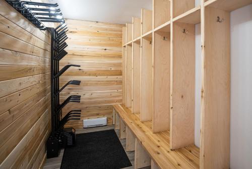 a sauna with wooden walls and a black rug at Mountain Dreams - Revelstoke Home Near RMR in Revelstoke