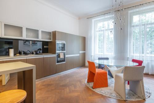 a kitchen and dining room with a table and chairs at Elegant Paris Ave apartment with a Terrace in Prague