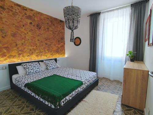 a bedroom with a bed and a large window at Art flat in center near to sea in Blanes