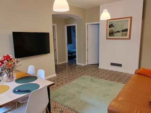 a living room with a couch and a table at Art flat in center near to sea in Blanes