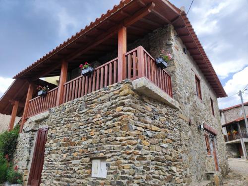a stone building with a balcony on top of it at Recanto da Encosta - T2 in Bragança
