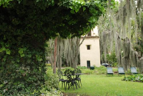 a table and chairs in a park with trees at Hacienda Suescún - 300 Años de Historia in Tibasosa
