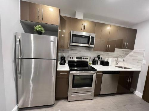 a kitchen with a stainless steel refrigerator and microwave at 305 Cozy and lovely 1BDR apartment in Center City in Philadelphia