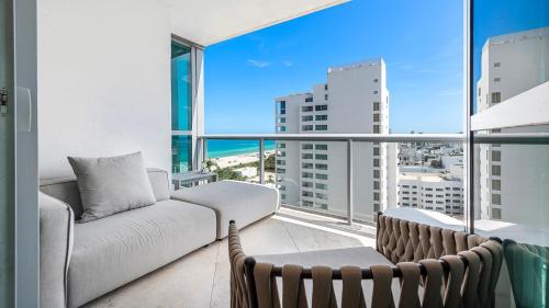 een woonkamer met een bank en een groot raam bij Oceanview Private Condo at The Setai -2102 in Miami Beach