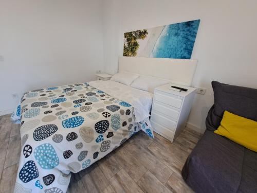a small bedroom with a bed and a couch at Mirador in Alicante