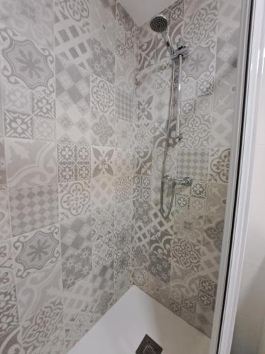 a shower in a bathroom with a tile wall at Mirador in Alicante