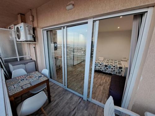 a small room with a balcony with a table and chairs at Mirador in Alicante