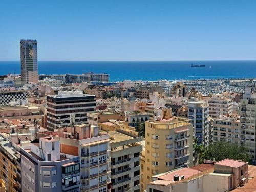 a city with buildings and the ocean in the background at Mirador in Alicante