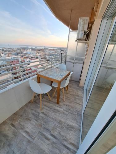 a balcony with a table and chairs and a view at Mirador in Alicante