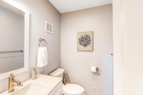 a white bathroom with a sink and a toilet at The Jewel of Elkhart, Upper Unit in Elkhart