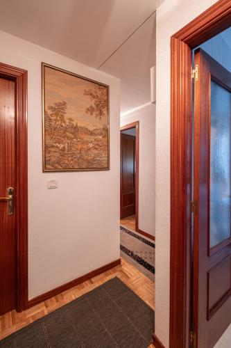 a hallway with a door and a painting on the wall at AguasBlancas VUT LE 446 in La Pola de Gordón