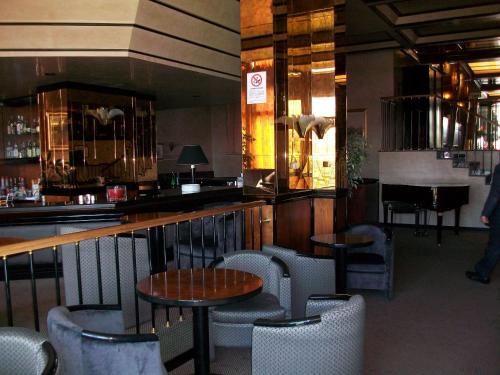 a restaurant with a bar with tables and chairs at Grande Albergo Potenza in Potenza