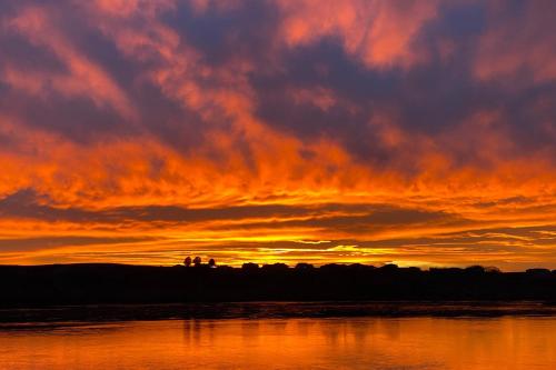 a sunset over a body of water with the sky at Columbia Vista in Richland