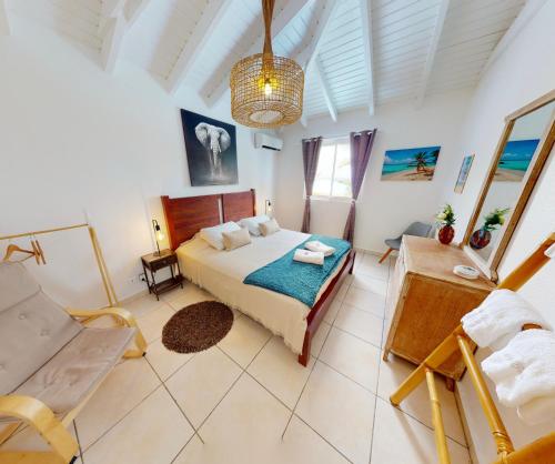a bedroom with a bed and a chair in it at Happy Friar's in Friar's Bay