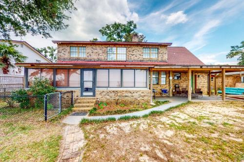 a large brick house with a yard at Get a Wave From it All in Pensacola