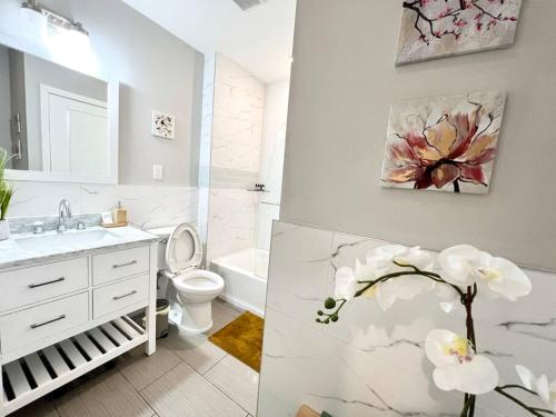 a bathroom with a sink and a toilet and a painting at 307 Kyoto style 1BDR Apt in center city in Philadelphia