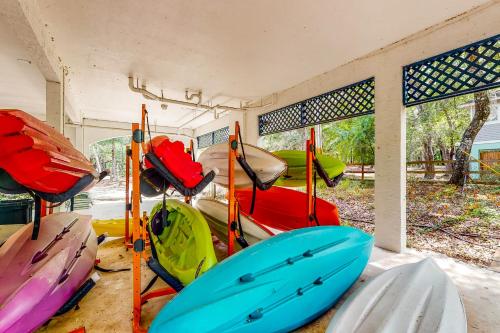 a group of kayaks are lined up in a room at River Watcher in Bell