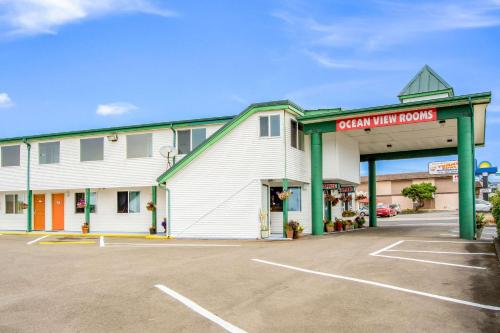 a large white building with a parking lot at Econo Lodge Newport in Newport