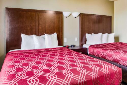 a hotel room with two beds with red sheets at Econo Lodge Newport in Newport