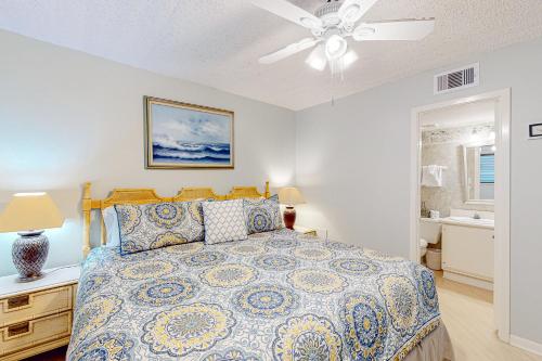 a bedroom with a bed and a ceiling fan at Ocean Bliss By the Sea in Galveston