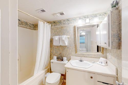 a bathroom with a sink and a toilet and a shower at Ocean Bliss By the Sea in Galveston