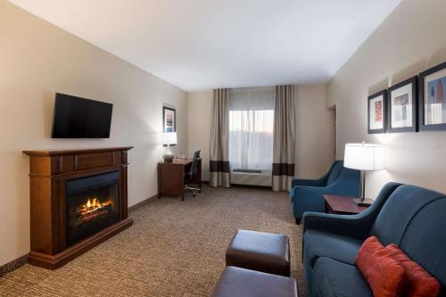 a hotel room with a living room with a fireplace at Comfort Suites Suffolk - Chesapeake in Suffolk