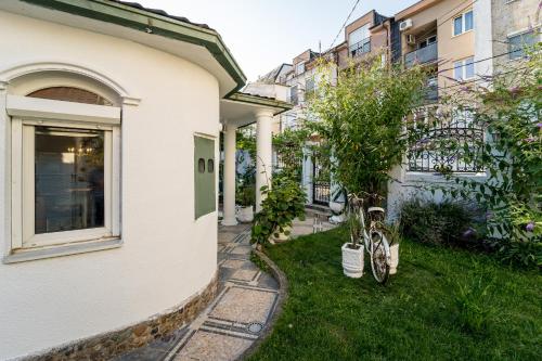 a bike parked in the grass next to a building at French House in Belgrade