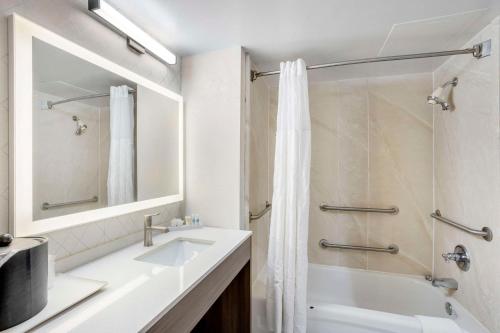 a white bathroom with a sink and a shower at Comfort Inn & Suites Voorhees-Mt Laurel in Voorhees