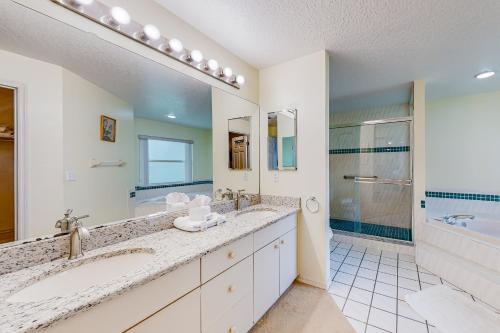 a bathroom with two sinks and a large mirror at Palm Bay Getaway in Palm Bay
