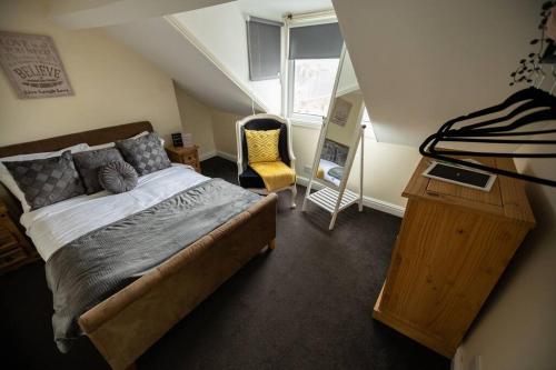 a bedroom with a bed and a desk and a chair at The Beach House -South Shields in South Shields