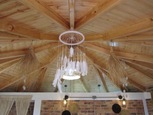 a chandelier hanging from a wooden ceiling in a room at Ecohotel, Finca Colinas y Senderos in Paipa