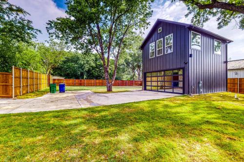 a purple house in a yard with a fence at McKinney Marvel in McKinney