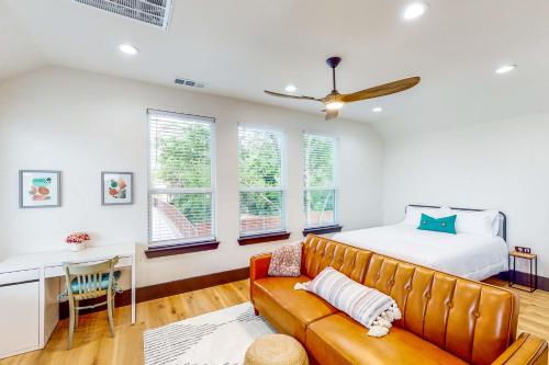 a bedroom with a bed and a desk and a couch at McKinney Marvel in McKinney