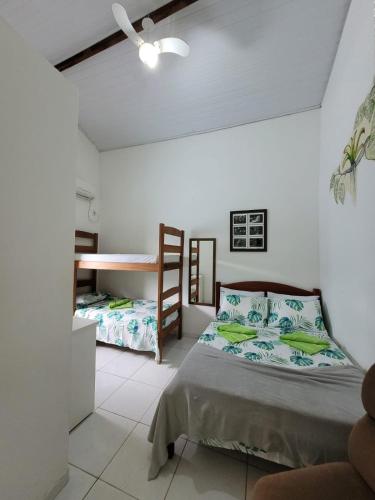 a bedroom with a bed and a bunk bed at Pousada Piçarras in Lençóis