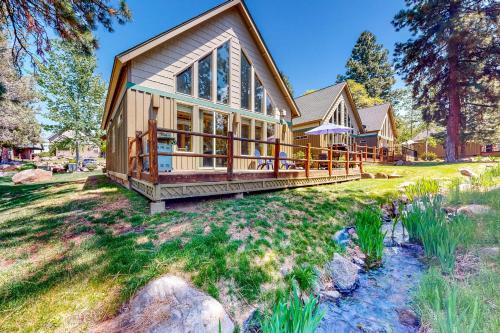 a large wooden house with a large porch at Marsh Hawk Cabin in Klamath Falls